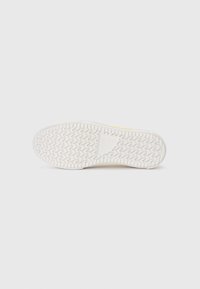 Shoe sole, rubber material, white color, textured with zigzag pattern for traction, rounded toe.