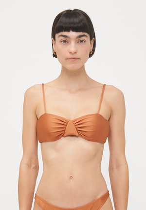 Brown bikini top with thin straps, featuring a twisted front design. Made from smooth fabric, it has a cohesive color and minimalist style.