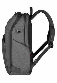 Gray fabric backpack with black accents, padded straps, multiple zippered compartments, and a side pocket. Sturdy design with a sleek profile.