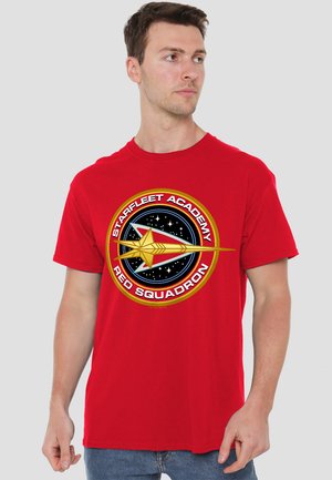 Red cotton t-shirt featuring a round Starfleet Academy Red Squadron logo with a yellow arrow design on a black starry background.
