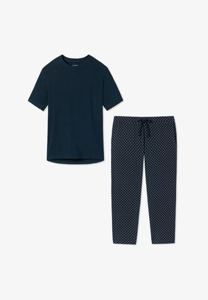 Marinblå bomullströja med korta ärmar, kombinerad med marinblå byxor prydda med vita prickar och en justerbar dragsko i midjan.