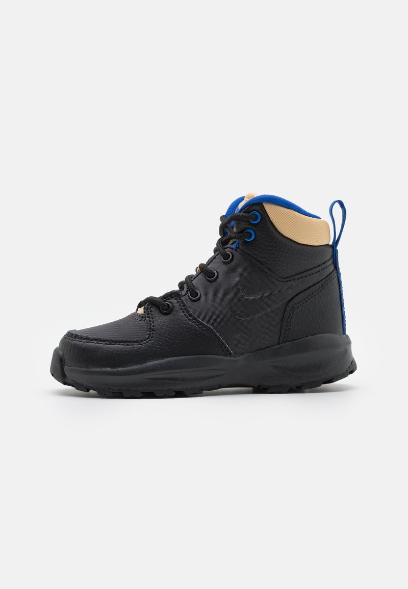 Black and tan mid-top sneaker with a textured leather upper, blue accents, lace-up closure, and a rubber sole. Features a pull tab at the heel.