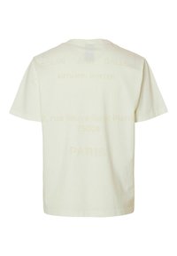 Crewneck t-shirt i lysebeige bomuld med subtilt trykt tekst på ryggen. Klassiske korte ærmer og en afslappet pasform. Ingen mønstre.