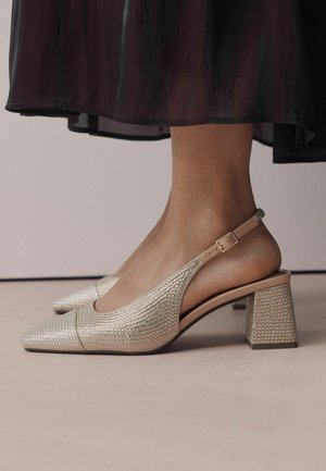 Slingback heels with a pointed toe, silver fabric covered in small rhinestones, chunky block heel, and adjustable ankle strap.