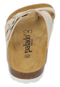 Palado-sandaler i beige med en korksula. Har en vadderad fotbädd i mocka och remmar med metalldetaljer.