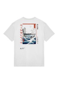 Hvid bomulds-t-shirt med et stort blåt bølgekunstværk med røde og sorte accenter, japansk tekst, og et mindre logo nederst.