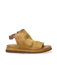 Tan leather sandal with an open toe, slouchy upper, and adjustable buckle strap. Flat sole with slight texture along the edge.