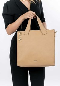 Beige Leder-Tote-Bag mit strukturiertem Finish, doppelten Oberhenkeln und goldfarbenen Beschlägen. Besitzt eine Schlüsselanhänger-Akzent auf einer Seite.