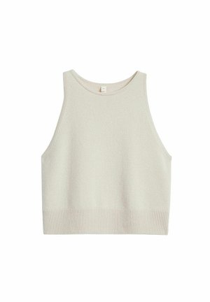 Jasnobeżowy krótki top na ramiączkach wykonany z miękkiego materiału. Posiada zaokrąglony dekolt, szerokie wycięcia na ramiona oraz prążkowany dół.