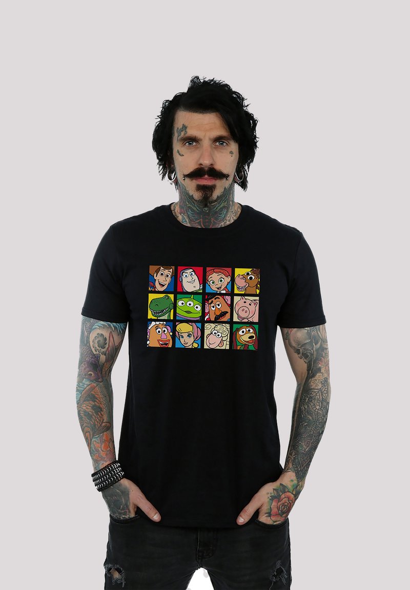 Black cotton t-shirt featuring a colorful graphic of cartoon character faces arranged in a grid pattern on the front.