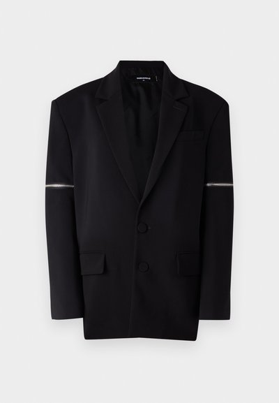 Black blazer with structured design, two front buttons, three pockets, and a unique zip detail on the left sleeve. Smooth, tailored fabric.