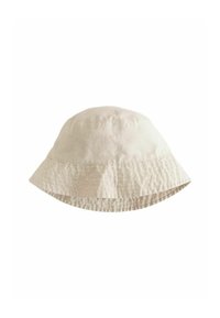 Chapeau seau en coton beige avec une texture douce, large bord flou et surpiqûres le long du bord. Design léger et décontracté.