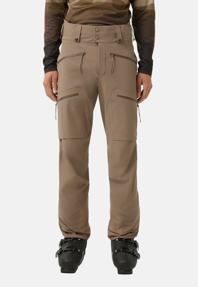 Beige Skihosen mit geradem Bein, mehreren Reißverschlusstaschen und einem verstellbaren Taillenbund mit Knopfverschluss. Glatte Stofftextur.