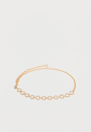 Gouden ketting met schakels in de vorm van elkaar overlappende ovalen, met een gepolijste en gestructureerde afwerking, verbonden door een fijne ketting.