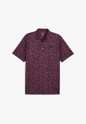 Polo a maniche corte di un colore bordeaux scuro con un motivo floreale, dotato di colletto, chiusura a tre bottoni e un tessuto morbido e testurizzato.