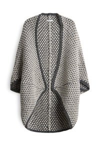 Cardigan en tricot épais avec un motif à pois noir et blanc, ouverture frontale, manches longues, et un bord foncé le long des bords et du col.