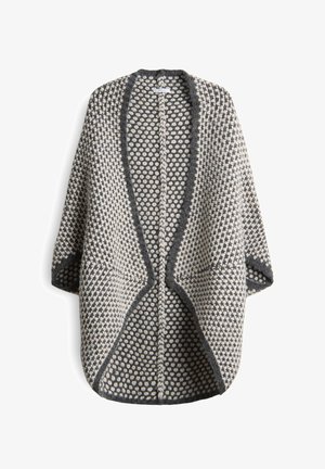 Cardigan dalla maglia grossa con motivo a pois nero e bianco, apertura frontale, maniche lunghe e bordi e colletto scuri.