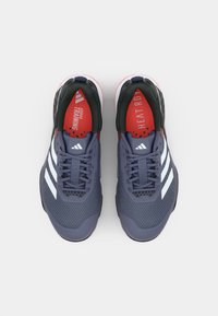 Dark navy athletic shoes with white three-stripe design, mesh upper, textured sole, and contrasting red and black interior accents.