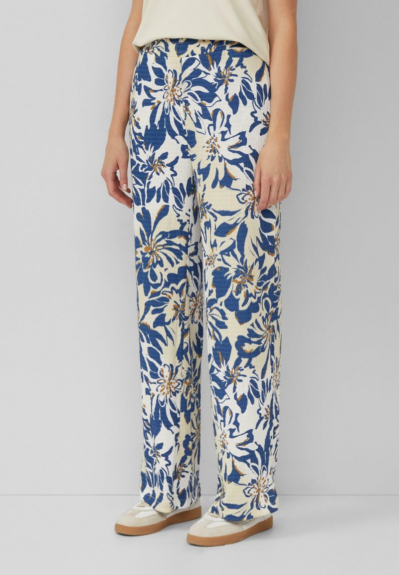 Floral print broek met wijde pijpen in crème met blauwe en oranje bloemen. Gemaakt van een geweven stof, met een hoge tailleband en een ontspannen pasvorm.