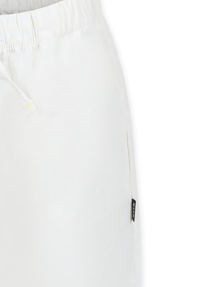Pantaloni corti bianchi con vita elastica, chiusura con cordino e tasche laterali. Presentano un piccolo etichetta nera sul lato. Texture liscia.