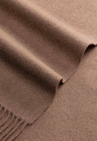 Soft, brown wool fabric with fringed edges, shown folded to highlight texture and thickness.