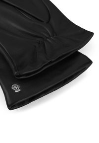 Pair of black leather gloves with gathered wrist detail and small metallic skull emblem on cuff against white background.