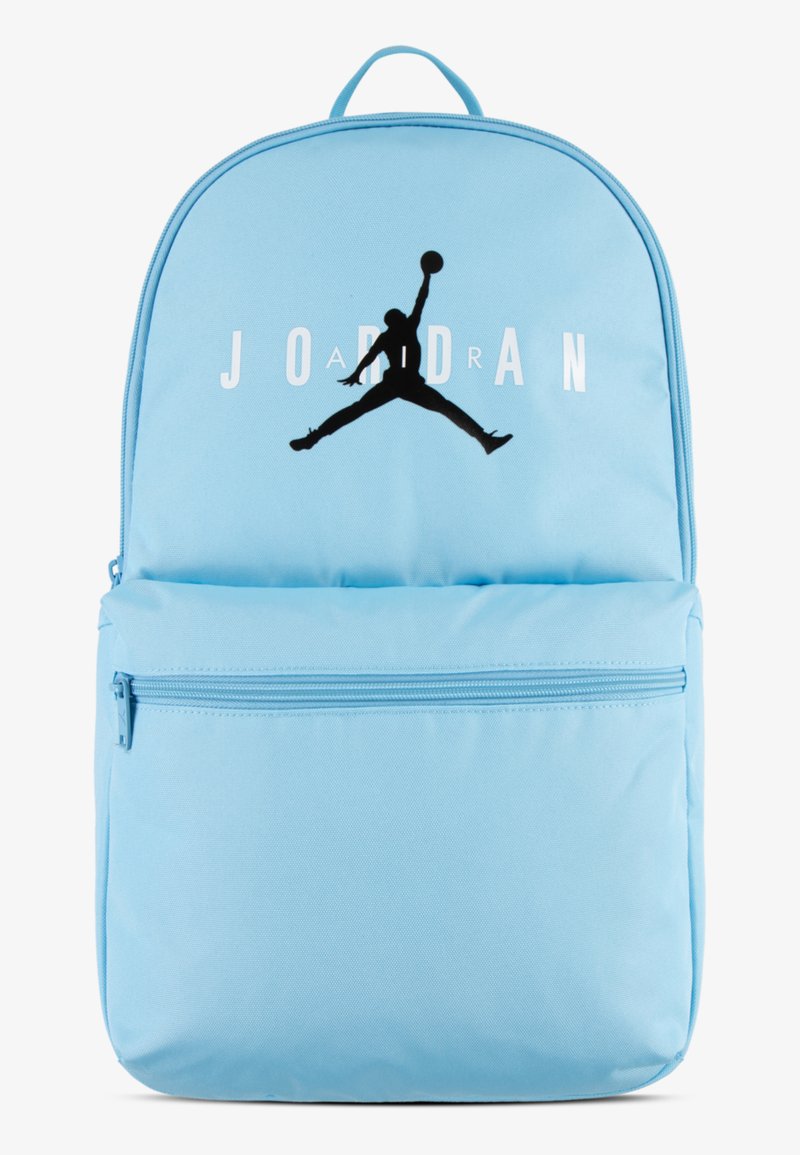 Light blue backpack made of fabric with a large black Jumpman logo and "JORDAN" printed in white. Features a front zip pocket and top handle.