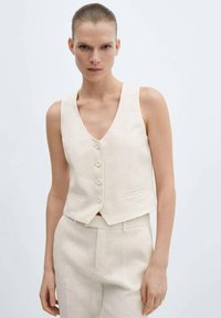 Beige linen sleeveless vest with a V-neck, five buttons, and two front pockets, featuring a tailored fit and smooth texture.