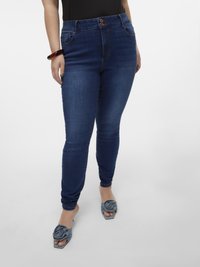 Blue skinny jeans with a high waist, two-button closure, front pockets, and a smooth texture. Paired with gray slide sandals featuring floral accents.