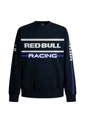 Tumepruun dressipluus, millel on valge ja lilla tekst "RED BULL" ja "RACING". Omab ühtlasi varrukaid ja soonikutes esemeid, valmistatud pehmest kudumist.