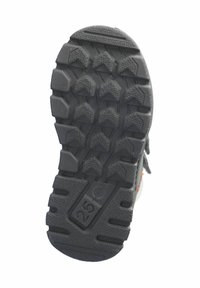 Suela de zapato de goma negra con patrones de relieve profundos y un marcado de tamaño visible de 25. Diseñada para ofrecer tracción y estabilidad.