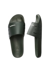 Sandales à glissière Havaianas vertes avec semelles texturées et larges brides présentant des motifs en relief de bande de roulement de pneu et un logo blanc embossé.