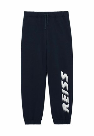 Pantaloni jogger blu navy con vita elastica, coulisse e scritta bianca "RISS" stampata verticalmente sulla gamba sinistra.