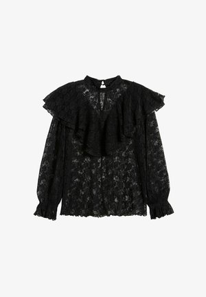 Musta pitsipaita, jossa on korkea kaulus, röyhelötilkku olkapäissä, pitkät hihat kootuilla hihansuilla ja avainaukko takana.