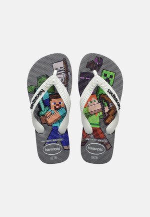 Kinder-Zehentrenner mit weißen Riemen und pixeligen Minecraft-Figuren, die Werkzeuge halten, auf grauen, strukturierten Sohlen, Größe 29-30.