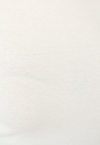 Light beige cotton fabric with a fine ribbed texture, smooth surface, and subtle variations in shade, forming a uniform appearance.