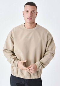 Beige sweatshirt van textiel met structuur, met een ronde hals, geribbelde manchetten en een elastische zoom. ‘Project Paris’ logo in lichtgroen.