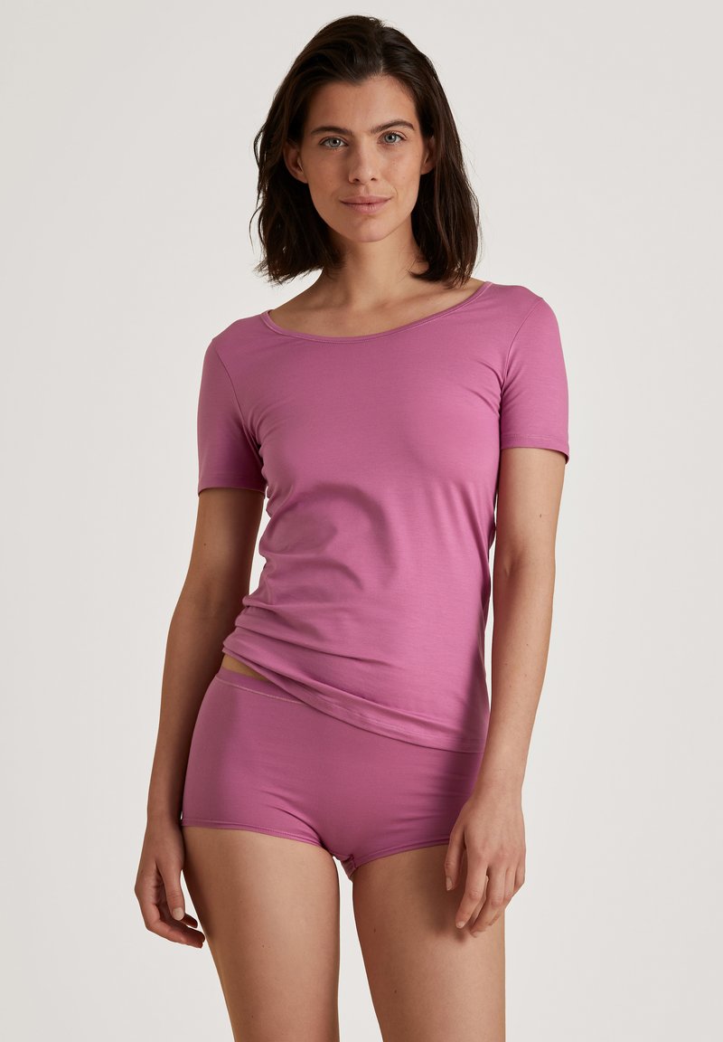 Pink, short-sleeved top with a wide neckline paired with matching shorts. Soft, stretchy fabric with smooth texture and minimal seams.