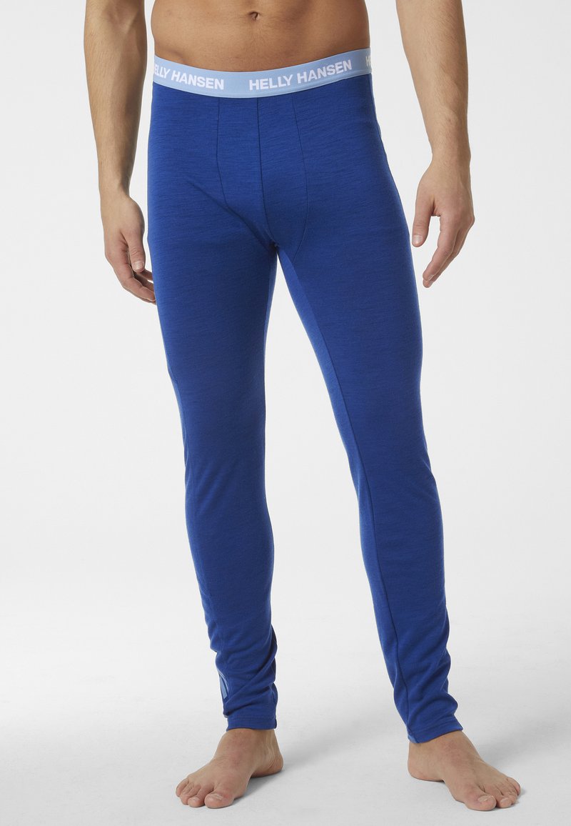 Blauwe thermoleggings met een zachte textuur en een strakke pasvorm, afgewerkt met een lichtgrijze elastische tailleband met het label "HELLY HANSEN."
