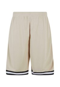 Beige mesh short med elastisk talje. Har sorte og hvide stribede detaljer ved kanten. Letvægts og åndbart stof.