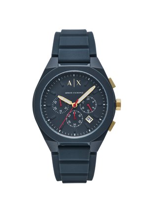 Black silicone watch with a round dial, gold accents, three chronograph sub-dials, and a date display at 6 o'clock.