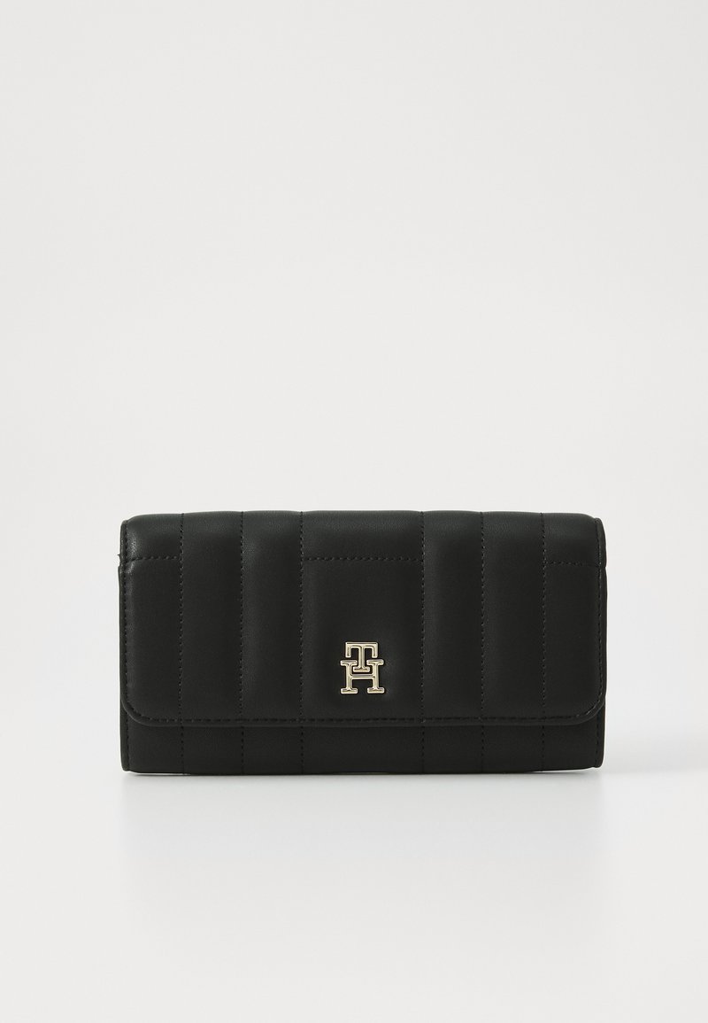 Black leather wallet with quilted design, gold hardware logo, and smooth texture. Features a flap closure and rectangular shape.