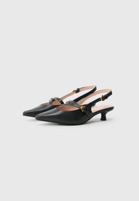 Black leather slingback shoes with a pointed toe, small kitten heel, and gold-tone hardware accents. Features cut-out design on the sides.