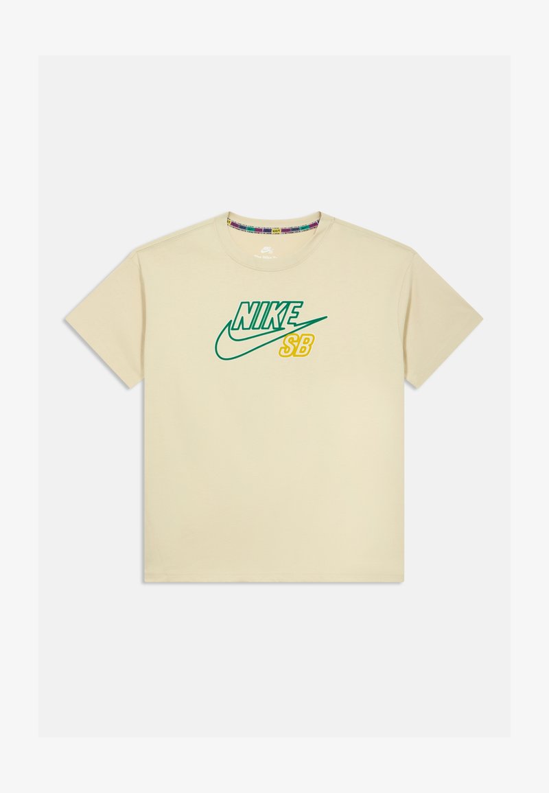 Béžové bavlněné tričko s logem "Nike SB" v zelené a žluté barvě. Kulatý výstřih, krátké rukávy a standardní střih.