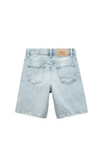 Shorts de mezclilla azul claro con un ajuste holgado, diseño de cinco bolsillos y una etiqueta de cuero en la parte posterior de la cintura. Textura deslavada y sutil desgaste.