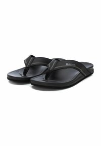 Chanclas negras con una plantilla texturizada y correas lisas. Cuentan con un separador de dedos y costuras de contraste en las correas. Suela de goma duradera.