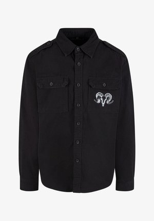 Must musta särgiga, millel on kaks rinna taskut, õlavarre epauletti ja valge rampealu skeem vasakul taskul. Puuvillane kangas.