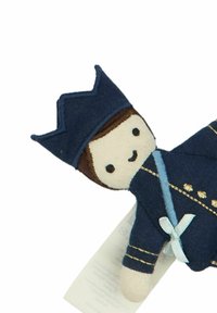 Soft fabric doll wearing a dark blue outfit with gold accents, a crown, and a light blue ribbon. Features a smiling face and light brown hair.