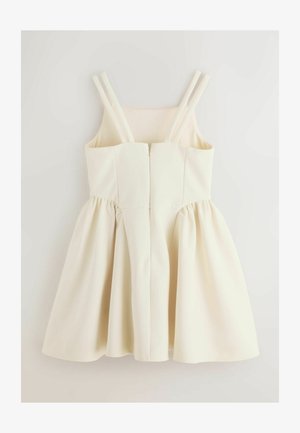 Krēmkrāsas bezroku kleita ar dubultiem plecu siksniņām, pieguļošu korseti, rāvējslēdzēju priekšpusē un savāktu, izplatu svārku.