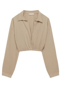 Blouse courte beige clair en tissu doux avec un col chemise et des manches longues. Dotée d'une taille froncée pour une coupe décontractée.